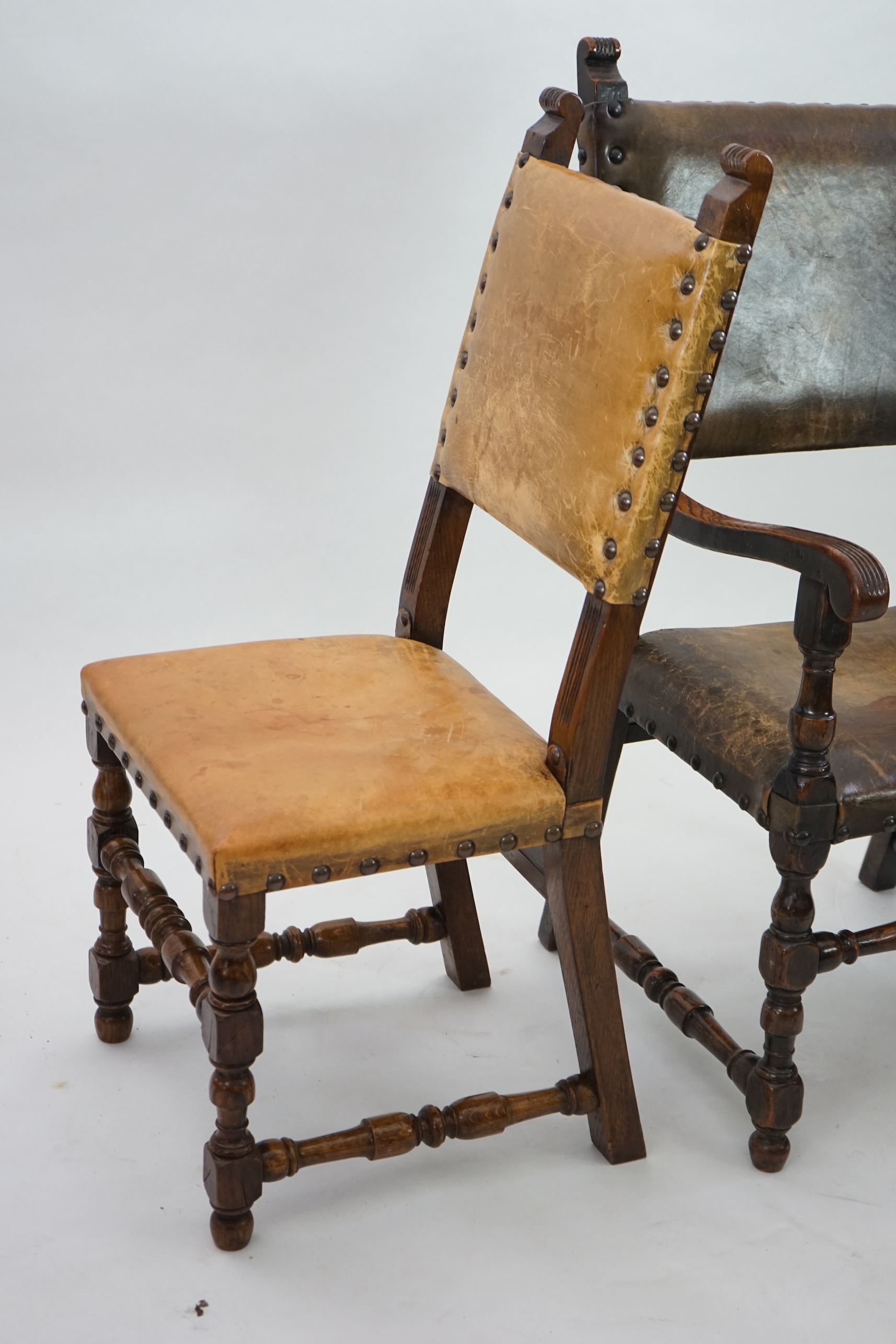 A set of fourteen 17th century style oak dining chairs including a pair of carvers